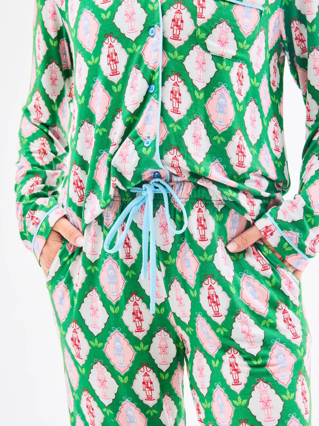 Christmas-themed green pajama set from Mary Square with pink geometric pattern on a white background