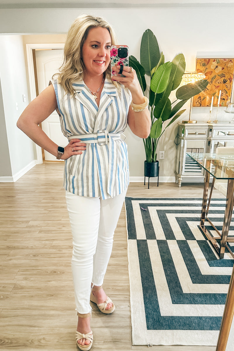 Model wearing a blue and white striped sleeveless jacket top with a matching belt from an online boutique.