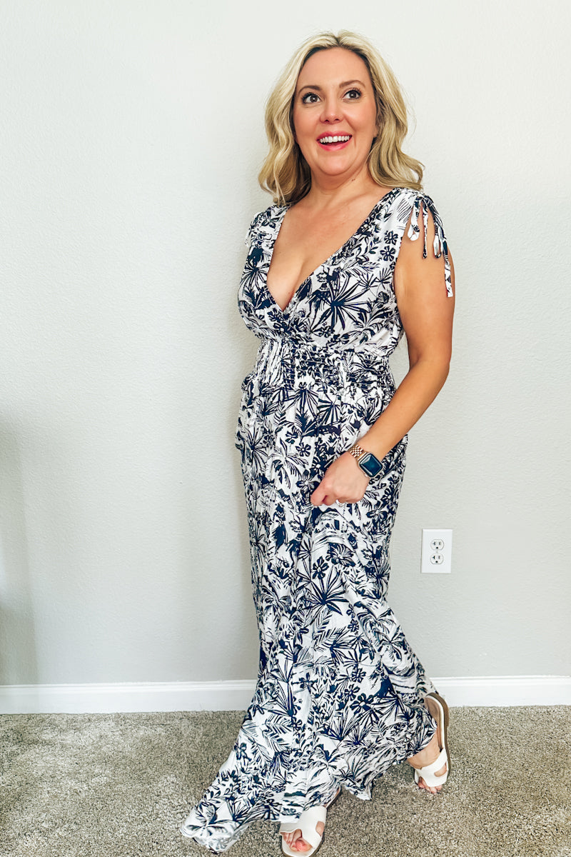 Three-quarter angle of a woman walking in The Hawaiian Toile Maxi Dress, paired with white flat sandals for a summer resort wear look.