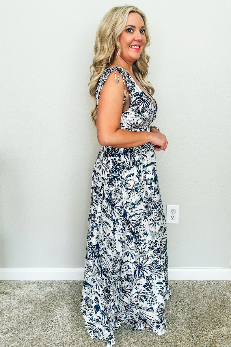 Side profile view of The Hawaiian Toile Maxi Dress highlighting the adjustable tie-shoulder straps and smocked bodice detail.