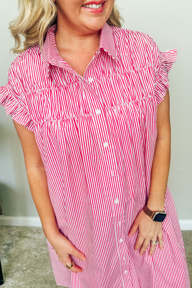 Close-up of the red and white striped Lexington Shirtdress, highlighting the classic collar, button-down front, ruched bodice detailing, and short ruffle sleeves.