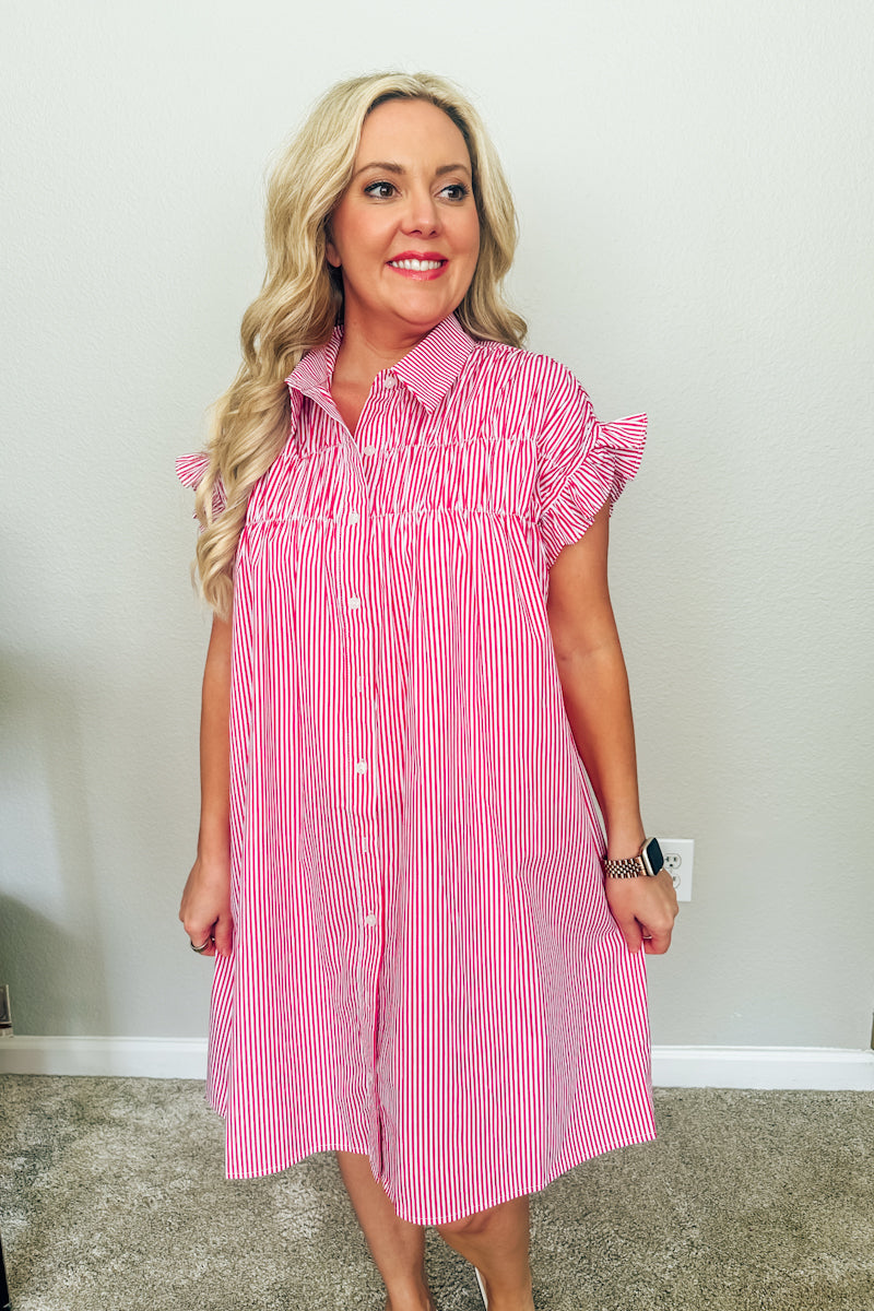 Three-quarter front view of the red striped Lexington button-down shirtdress, emphasizing the loose, comfortable resort wear fit.